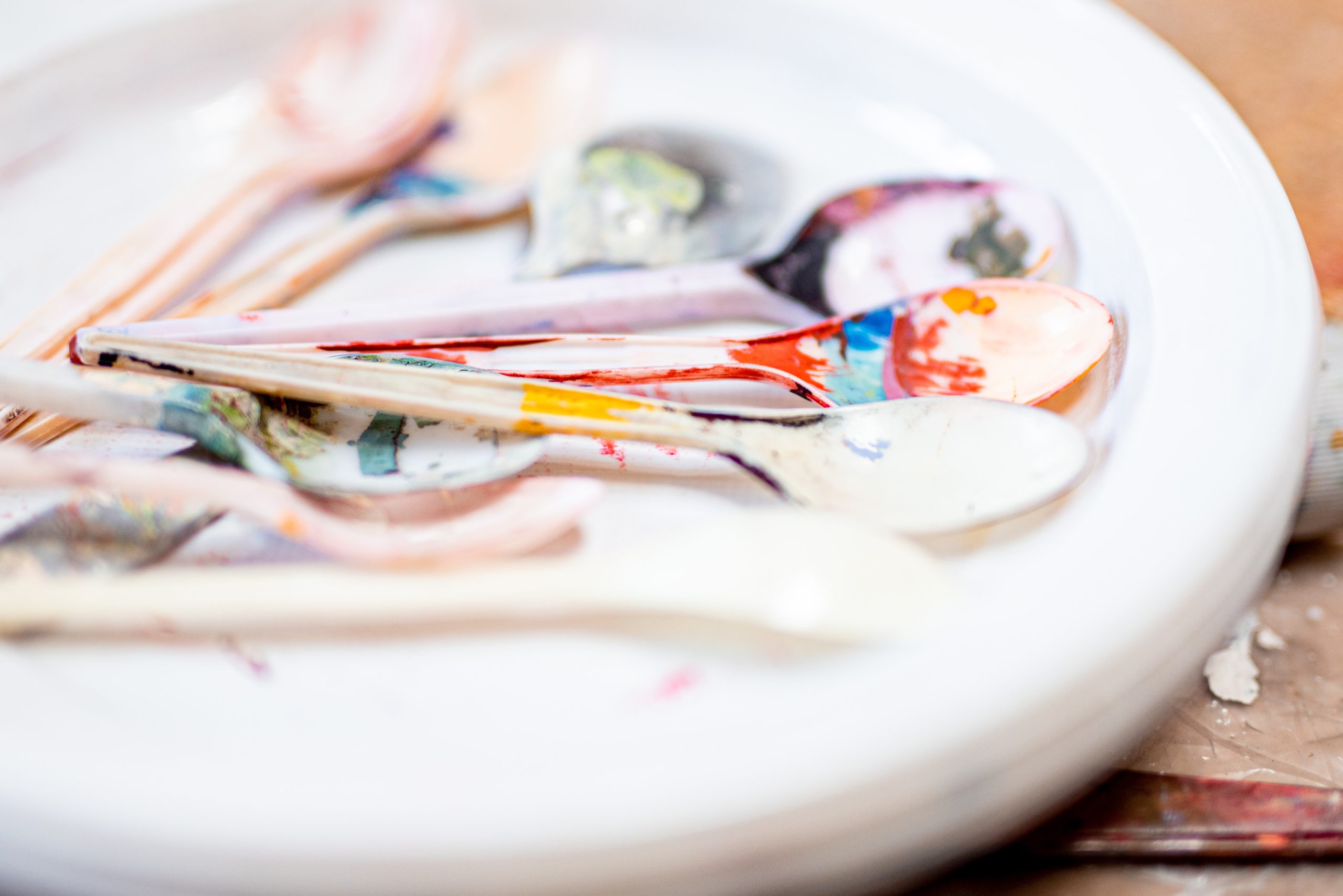 Close up of paint covered spoons used in art therapy session